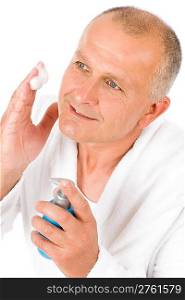Male cosmetics - senior mature man wash face with foam