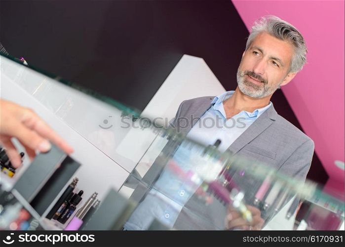 Male customer behind glass counter