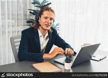 Male customer service operator or telesales agent sitting at desk in office, wearing headset and engage in conversation with client to provide support or close sales. Call center portrait. Entity. Male customer service operator or telesales agent portrait. Entity