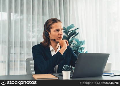 Male customer service operator or telesales agent sitting at desk in office, wearing headset and engage in conversation with client to provide support or close sales. Call center portrait. Entity. Male customer service operator or telesales agent portrait. Entity