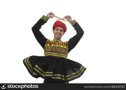 Male dandiya dancer dancing with sticks