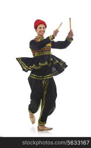 Male dandiya dancer dancing with sticks