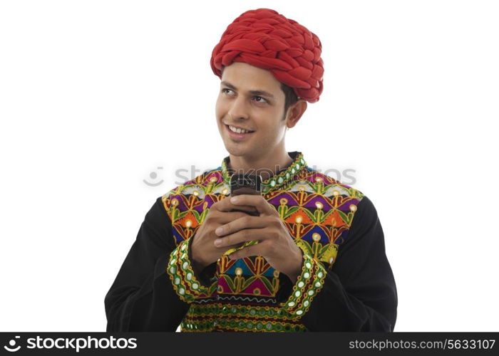 Male dandiya dancer with a mobile phone