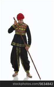 Male dandiya dancer with a stick