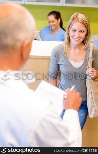 Male dentist calling next patient appointment for dental checkup