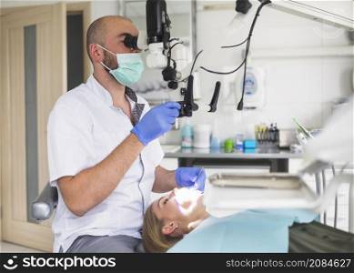 male dentist treating root canal female patient