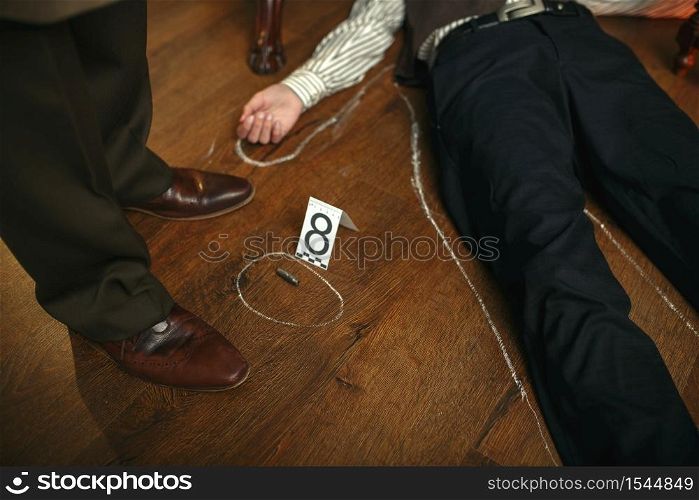 Male detective and victim&rsquo;s body circled with chalk at the crime scene, retro style. Criminal investigation, inspector is working on a murder, vintage room interior on background. Detective and victim&rsquo;s body circled with chalk