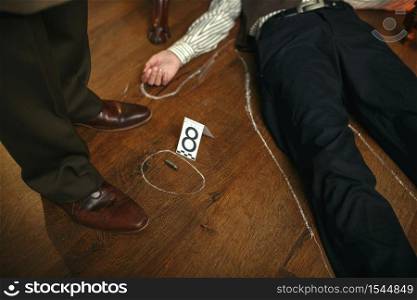 Male detective and victim&rsquo;s body circled with chalk at the crime scene, retro style. Criminal investigation, inspector is working on a murder, vintage room interior on background. Detective and victim&rsquo;s body circled with chalk