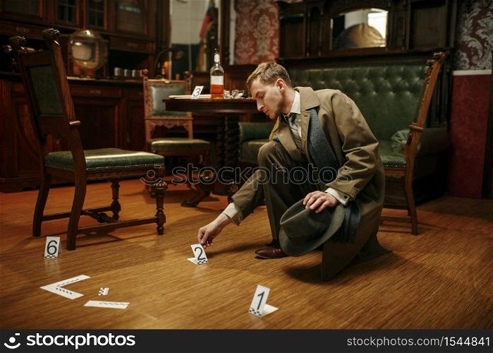 Male detective in coat collecting evidence at the crime scene, retro style. Criminal investigation, inspector is working on a murder, vintage room interior on background. Detective collecting evidence at the crime scene