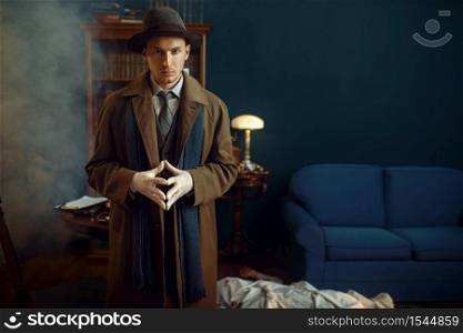 Male detective in gloves, victim under the cape at the crime scene, retro style. Criminal investigation, inspector is working on a murder, vintage room interior on background. Male detective in gloves, victim under the cape