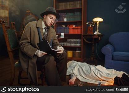Male detective with cigar writes in notebook, victim under the cape at the crime scene, retro style. Criminal investigation, inspector is working on a murder, vintage room interior on background. Male detective with cigar writes in notebook