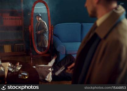 Male detective with gun standing at the mirror, crime scene, retro style. Criminal investigation, inspector is working on a murder, vintage room interior on background. Male detective with gun standing at the mirror