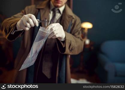 Male detective with tweezers finds sleeve, evidence at the crime scene, retro style. Criminal investigation, inspector is working on a murder, vintage room interior on background. Male detective with tweezers finds sleeve