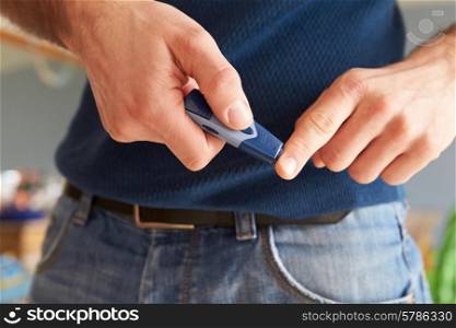 Male Diabetic Checking Blood Sugar Levels