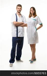 Male doctor and female nurse joyfully looking into the frame, full growth, isolated on white background