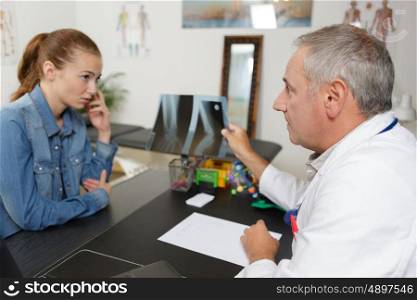male doctor and female patient discuss xray