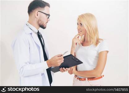 Male doctor and female patient with documents of patients health record are having conversation in hospital. Healthcare and medical service.. Male Doctor and Female Patient in Hospital Office