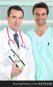 Male doctor and nurse with clipboard