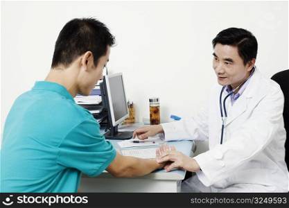 Male doctor checking a patient&acute;s pulse