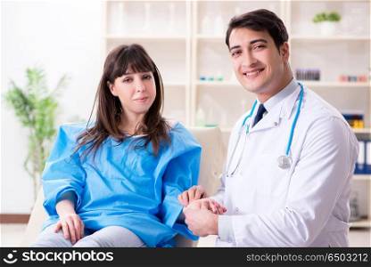 Male doctor checking up female patient in hospital