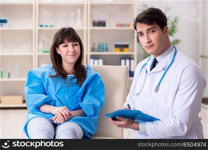Male doctor checking up female patient in hospital