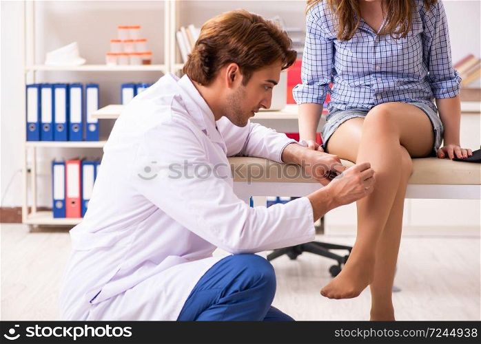 Male doctor checking with sensory hammer. The male doctor checking with sensory hammer
