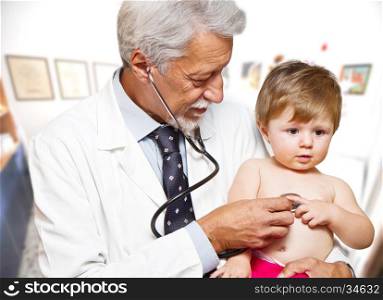 Male doctor examining a child patient