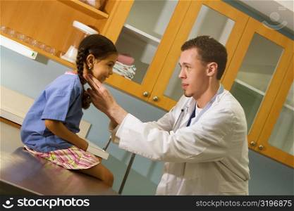 Male doctor examining a girl