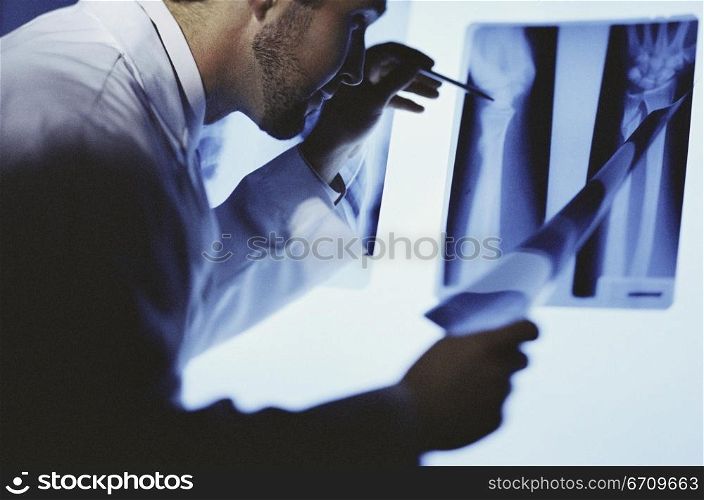 Male doctor examining an X-ray