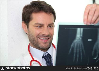 Male doctor examining x-ray image