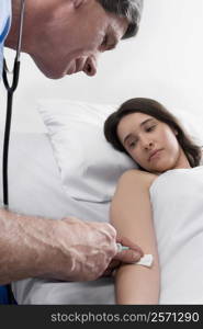 Male doctor giving an injection to a female patient