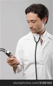 Male doctor holding a blood pressure gauge