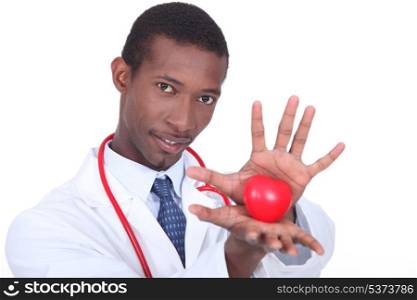 Male doctor holding heart shaped toy