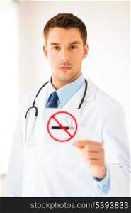 male doctor holding no smoking sign in hands