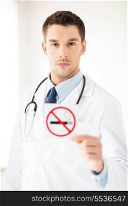 male doctor holding no smoking sign in hands