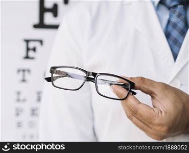 male doctor holding pair eyeglasses his hands. Resolution and high quality beautiful photo. male doctor holding pair eyeglasses his hands. High quality and resolution beautiful photo concept