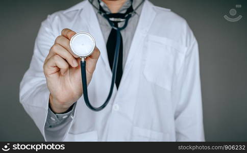 Male doctor holding stethoscope.