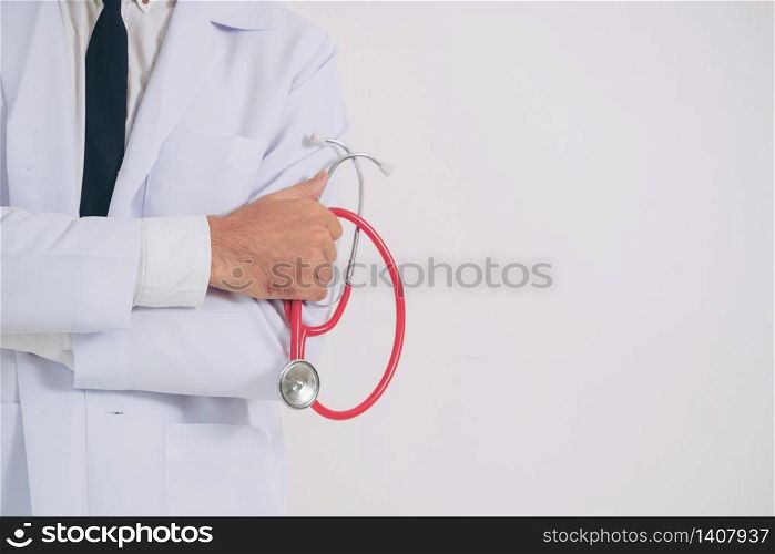 Male doctor holding stethoscope on white background. Medical and healthcare concept.. Doctor holding stethoscope on white background.