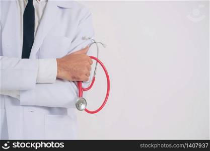 Male doctor holding stethoscope on white background. Medical and healthcare concept.. Doctor holding stethoscope on white background.