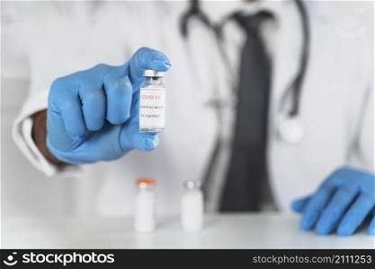 male doctor holding vaccine recipient close up