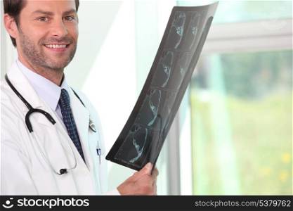 Male doctor holding x-ray