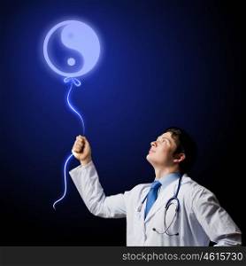Male doctor. Image of young male doctor and sign of yin yang