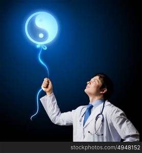 Male doctor. Image of young male doctor and sign of yin yang