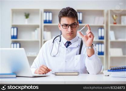 Male doctor in anti-smoking conceptwithcigarette pack
