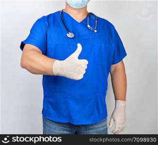 male doctor in blue uniform and latex white gloves shows right hand gesture like, thumb raised up