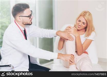 Male doctor is examining female patient in hospital ward. Healthcare and medical service.. Male Doctor and Female Patient in Hospital.