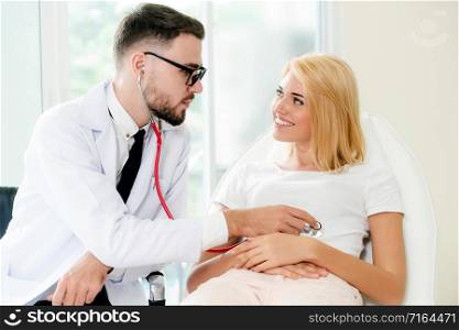 Male doctor is talking and examining female patient in hospital office. Healthcare and medical service.. Male Doctor and Female Patient in Hospital Office