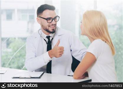 Male doctor is talking with female patient in hospital office. Healthcare and medical service.. Male Doctor and Female Patient in Hospital Office