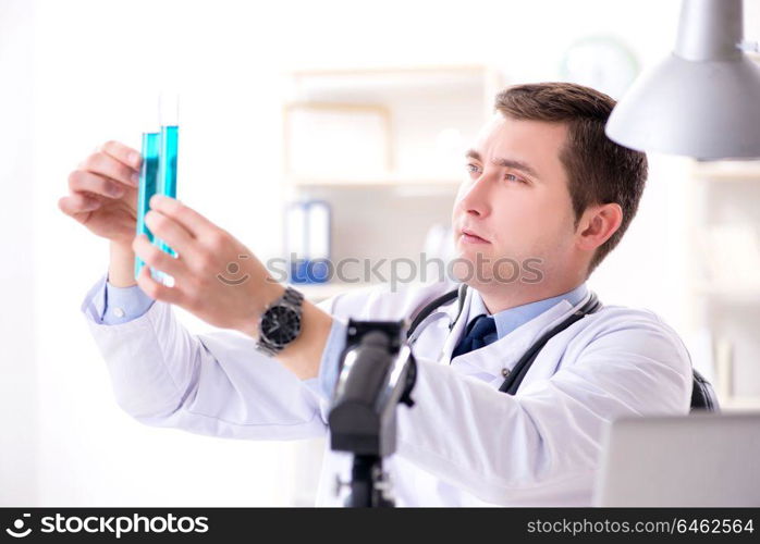 Male doctor looking at lab results in hospital