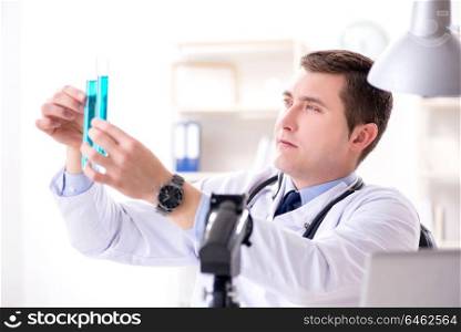 Male doctor looking at lab results in hospital